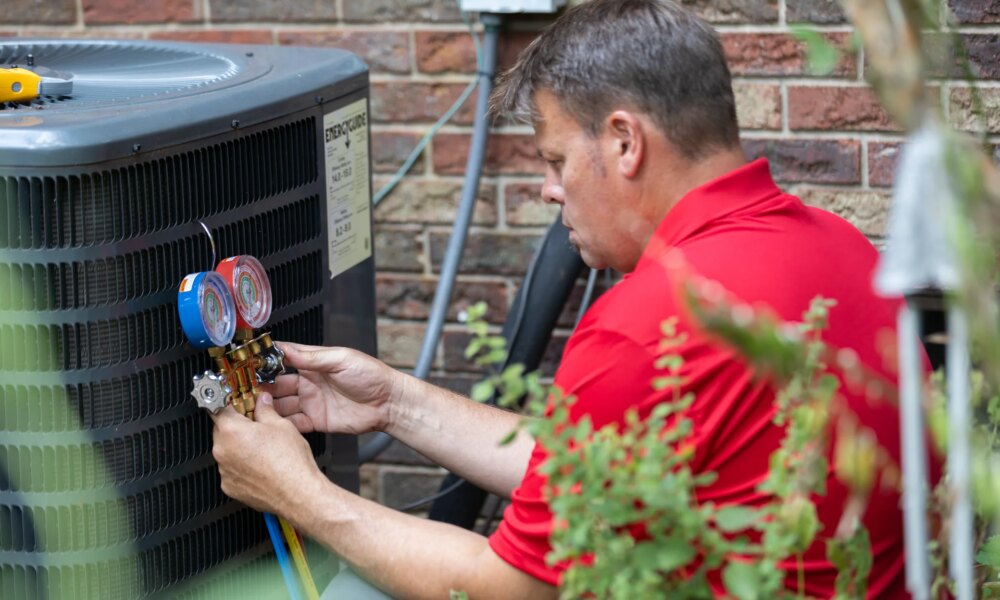 HVAC technician testing AC capacitor on Florida residential condenser